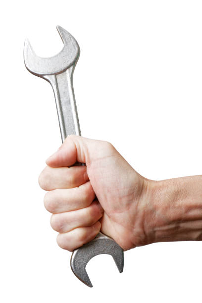 istock Closeup mans hand holds a wrench 958662314