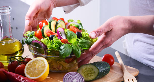 istock Preparation of a vegetable salad from fresh organic ingredients 958663044