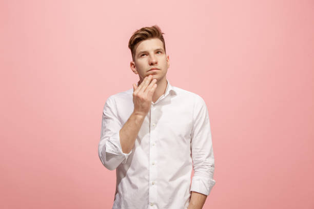 istock Young serious thoughtful businessman. Doubt concept 958663802