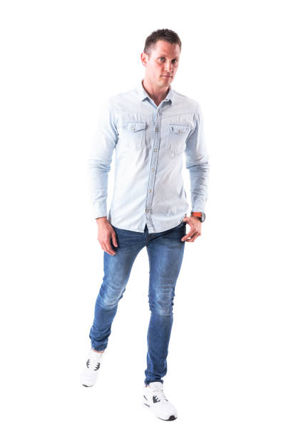 istock Serious confident young adult man looking and walking towards camera 958663816