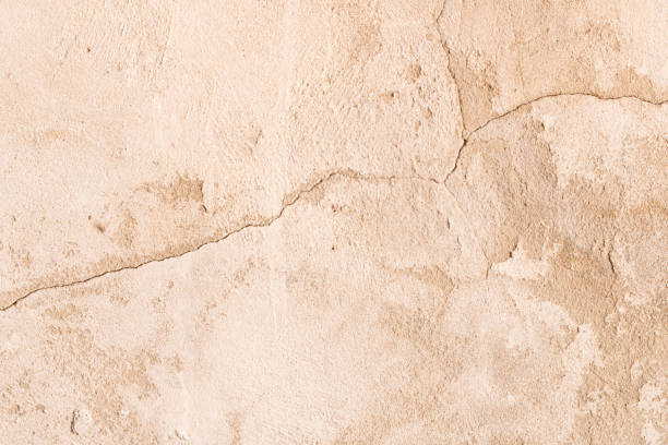 istock An old crumbling cement wall . Background texture of old wall 958667096