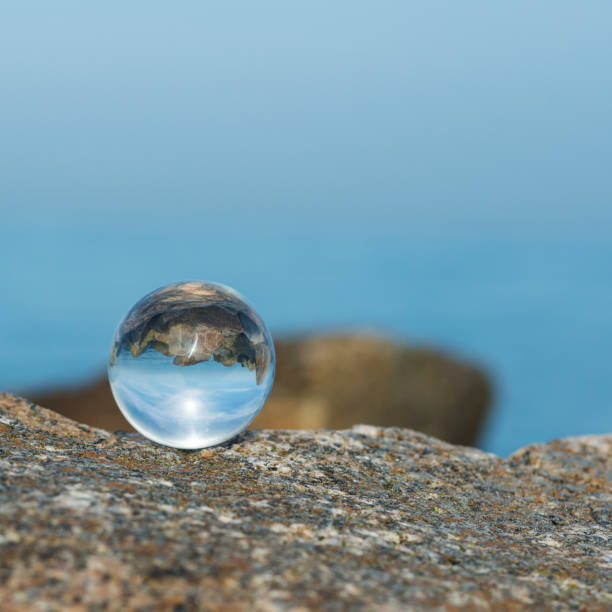 istock Crystal ball with reflection of rocky coastline 958667552