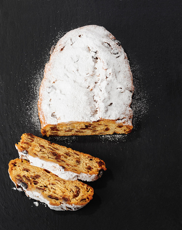 Traditional Christmas Stollen over black background
