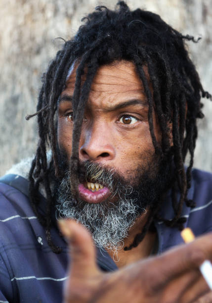 istock Homeless man with dreadlocks looks upset and angry 958671428