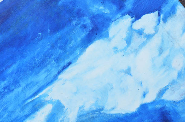 istock White watercolor smears on a blue canvas. 958673134