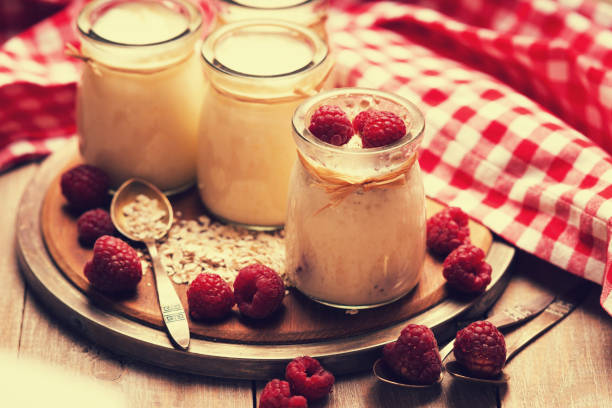 istock Jars with yogurt, raspberries and oat flakes 958674400