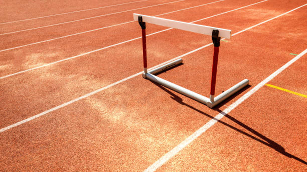 istock hurdle race barrier on red  running track , athletic stadium 958676710