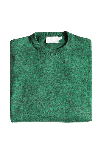 Green knitted wool folded sweater on white background
