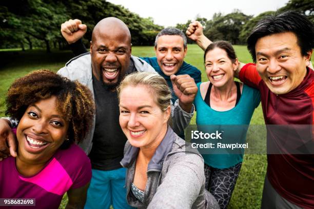 Grupo De Amigos Diversos Alegres En El Parque Foto de stock y más banco de imágenes de Grupo multiétnico - Grupo multiétnico, Grupo de personas, Ejercicio físico