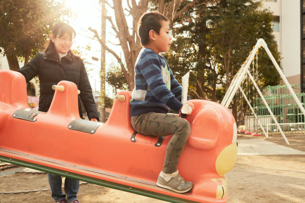 istock Brothers playing in park at the evening 958683438