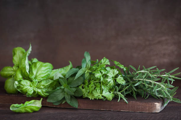 istock Fresh aromatic herbs on on rustic wooden background. 958683612