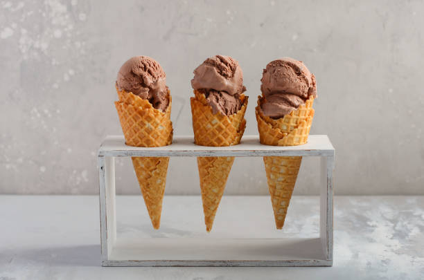 istock Chocolate ice cream in waffle cone on gray concrete background. 958686752