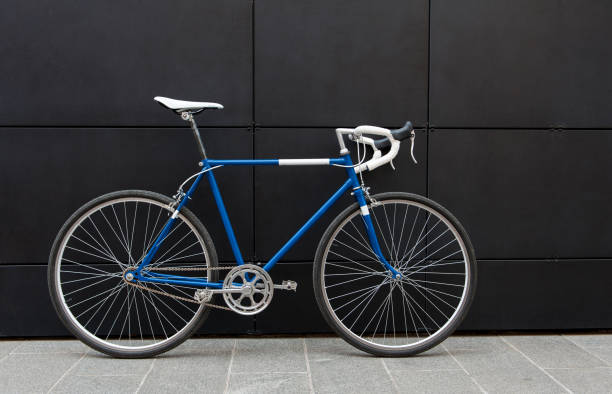 istock Vintage blue city bicycle against a black wall 958687296