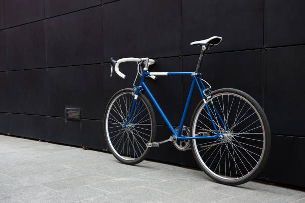 istock Vintage blue city bicycle against a black wall 958687456