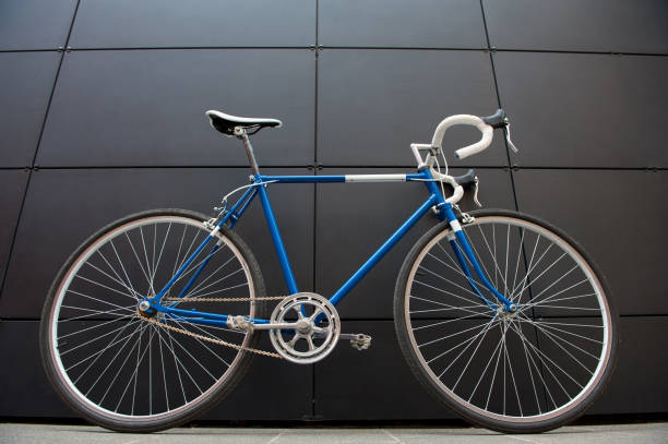 istock Vintage blue city bicycle against a black wall 958687590