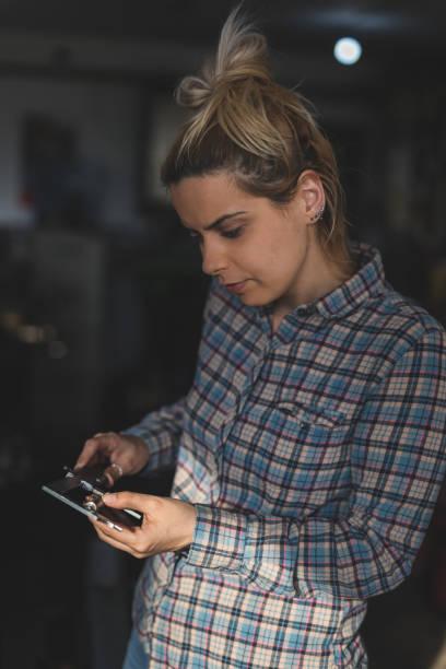istock Woman in workshop measures products 958688846