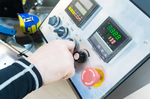 istock A close-up of a man's hand holds a rotary switch on the equipment control panel with instruments 958689118