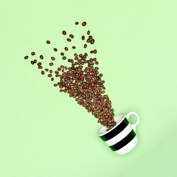 Creative pop art cup of coffee pastel coloured background. Coffee mug and roasted coffee beans concept.