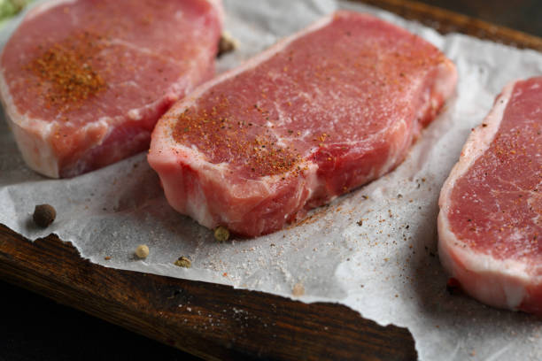 istock Uncooked meat slice on board, food raw 958689372