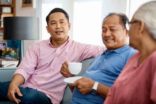 istock Father having coffee while sitting with family 958689624