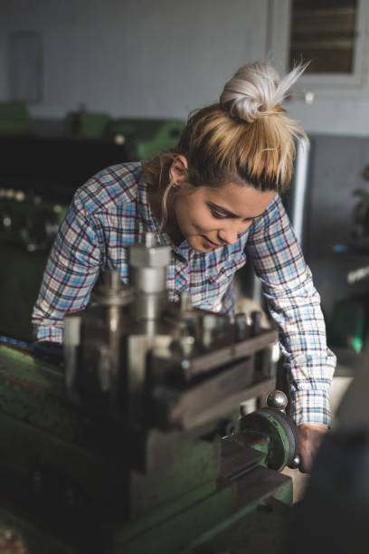 istock Young woman working in metal industry 958689748