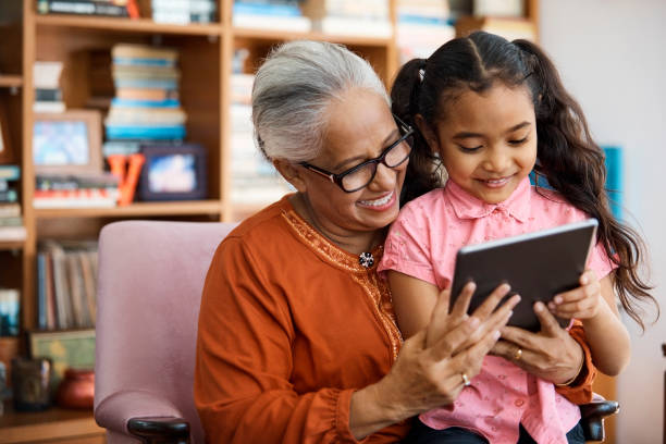 istock Grandmother and granddaughter with digital tablet 958689848