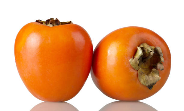 istock Two ripe persimmon fruits isolated on white 958693480