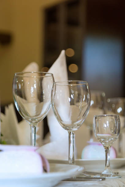 istock Three glasses. Banquet, tables, flowers, glasses, plates. 958693546