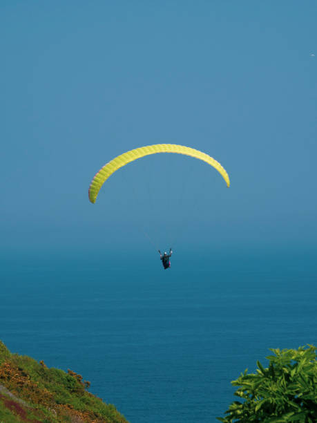 istock Paragliding flying over hills and the sea 958693828