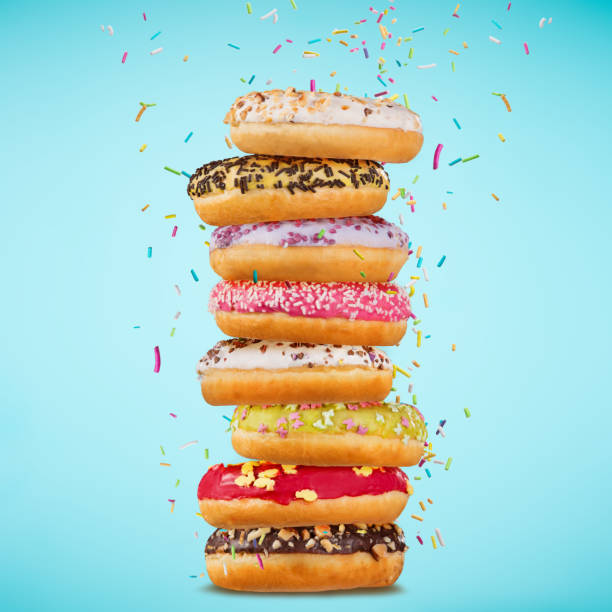 tasty doughnuts on pastel blue background - stack rock imagens e fotografias de stock