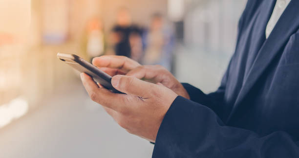 istock Businessman asian using phone for celling and texting on her mobile phone 958697082