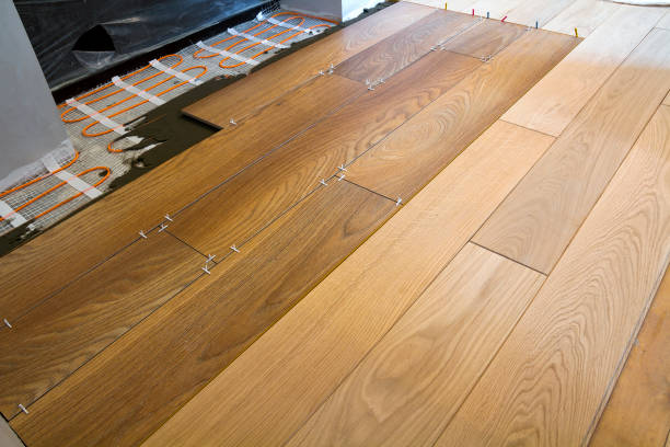 istock Installation of ceramic tiles and heating elements in warm tile floor. Renovation and improvement concept. 958697828