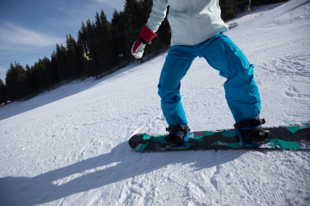 istock woman snowboarding in winter mountains 958697834