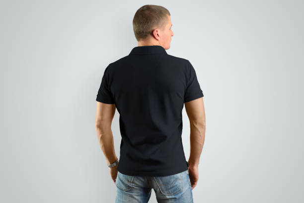 istock Back Mockup  black polo  shirt on a male model for an example design. 958698706