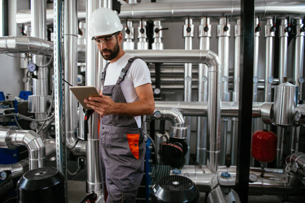 istock Engineer in boiling room with tablet and walkie-talkie 958698884