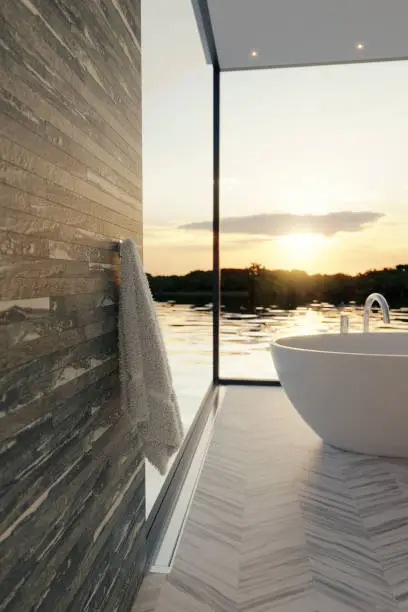 3d rendering of elegant bathroom with freestanding bathtub in front of beautiful lake in the evening sunset