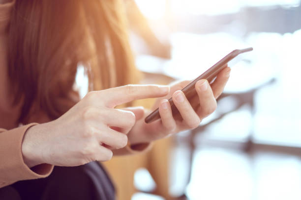 istock Woman hand holding smartphone. 958702214