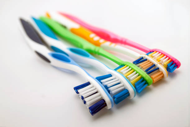 istock Colorful toothbrushes on white background with copy space. Macro with shallow dof. 958702394