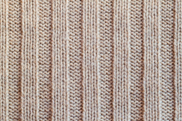 istock Creamy knitted wool warm clothes for the winter fabric texture background 958702432