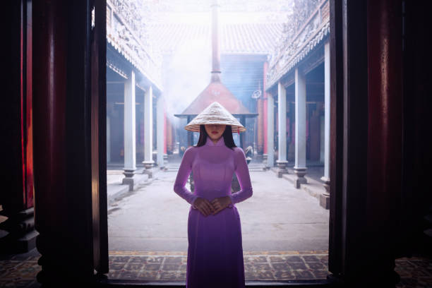 Vietnam woman wearing Ao Dai culture traditional. Vietnam woman wearing Ao Dai culture traditional at old temple in Vietnam,vintage style,travel and relaxing concept. ao dai stock pictures, royalty-free photos & images