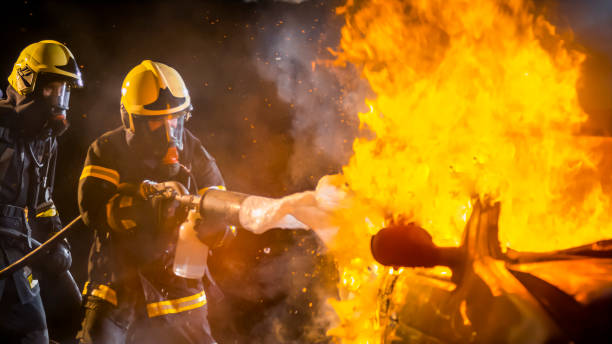 istock Firefighters spraying firefighting foam on burning car 958704450