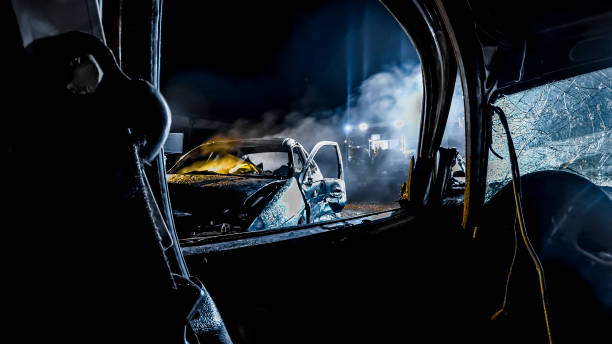 Car accident Crashed car burning at night. car accident stock pictures, royalty-free photos & images