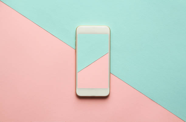 istock white cellphone on diagonal pastel pink and blue background. 958706722