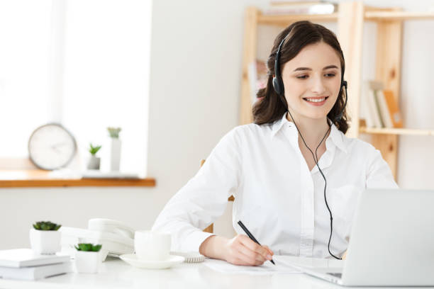 istock Call Center Concept: Portrait of happy smiling female customer support phone operator at workplace. 958707112