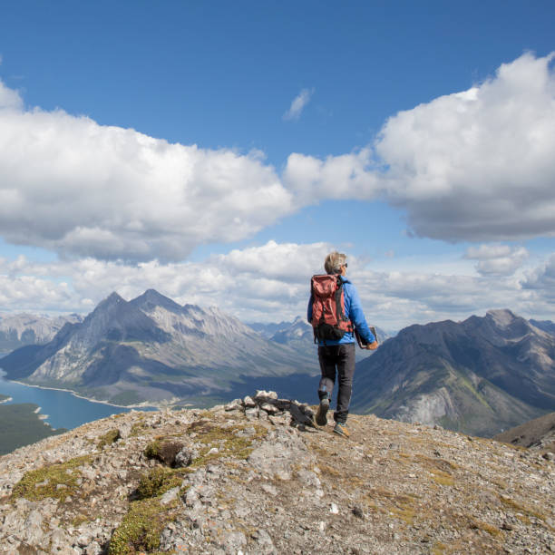istock Mountain hiker carries ipad up ridge crest 958707848