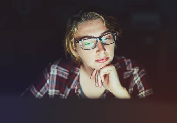istock Young woman working late on computer looks thoughtful 958712728