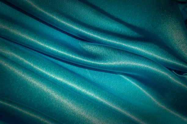istock Texture, fabric, background. Abstract background of luxurious fabric or liquid waves or wavy grunge crease silk satin texture of velvet material or luxurious Christmas or elegant background. Blue 958712808