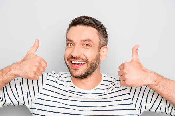 istock Happy smiling man with beard showing thumbs up 958713016