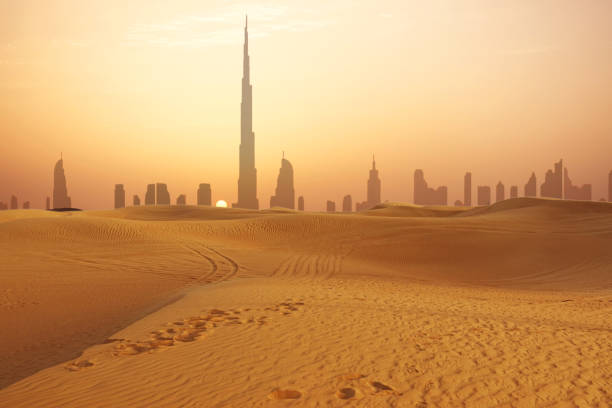 Dubai city skyline at sunset seen from the desert stock photo