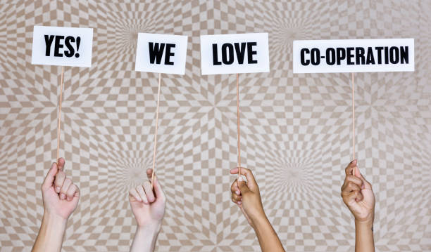 istock Four hands hold up sign: 